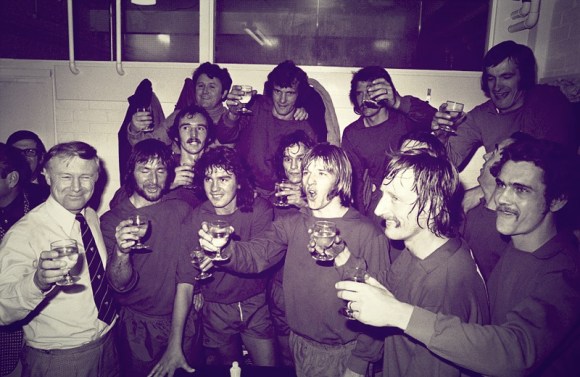 Walton and Hersham players raise a cheer to their 4-0 win in the dressing room