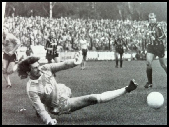 In the striped shirt second front left in the background, Mat watches his side take the lead against Dortmund