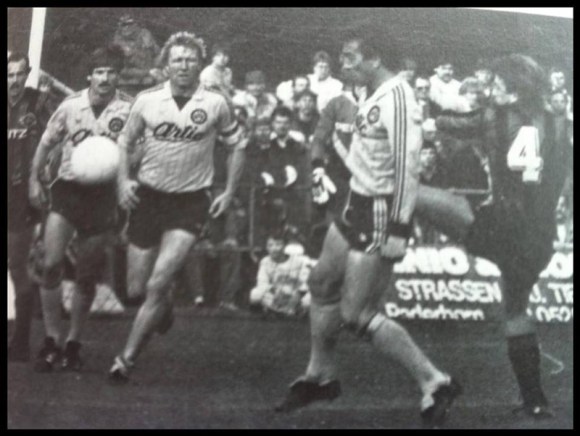 Playing against Borrussia Dortmund, Mat is the number 4 with the high-footed tackle to challenge Romanian international  Raducanu whilst Hurst Hrubesch, the German International, looks on