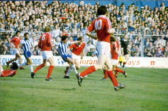 Martin Chivers watches on as Lawrenson gets into the thick of the action