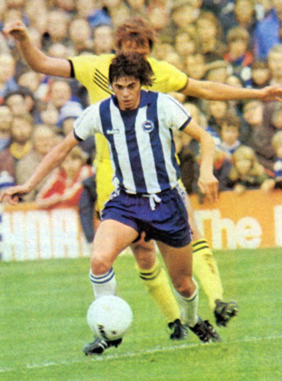 Brave as well as skilful. . . Ward keeps close control despite the attentions of a defender who dwarfs him.